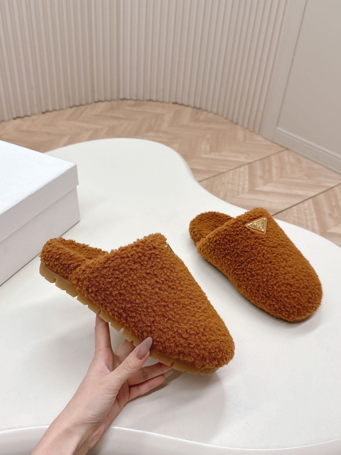 PRADA MULES ATTACHED TRIANGLE LOGO IN BRONZE BROWN SHEARLING