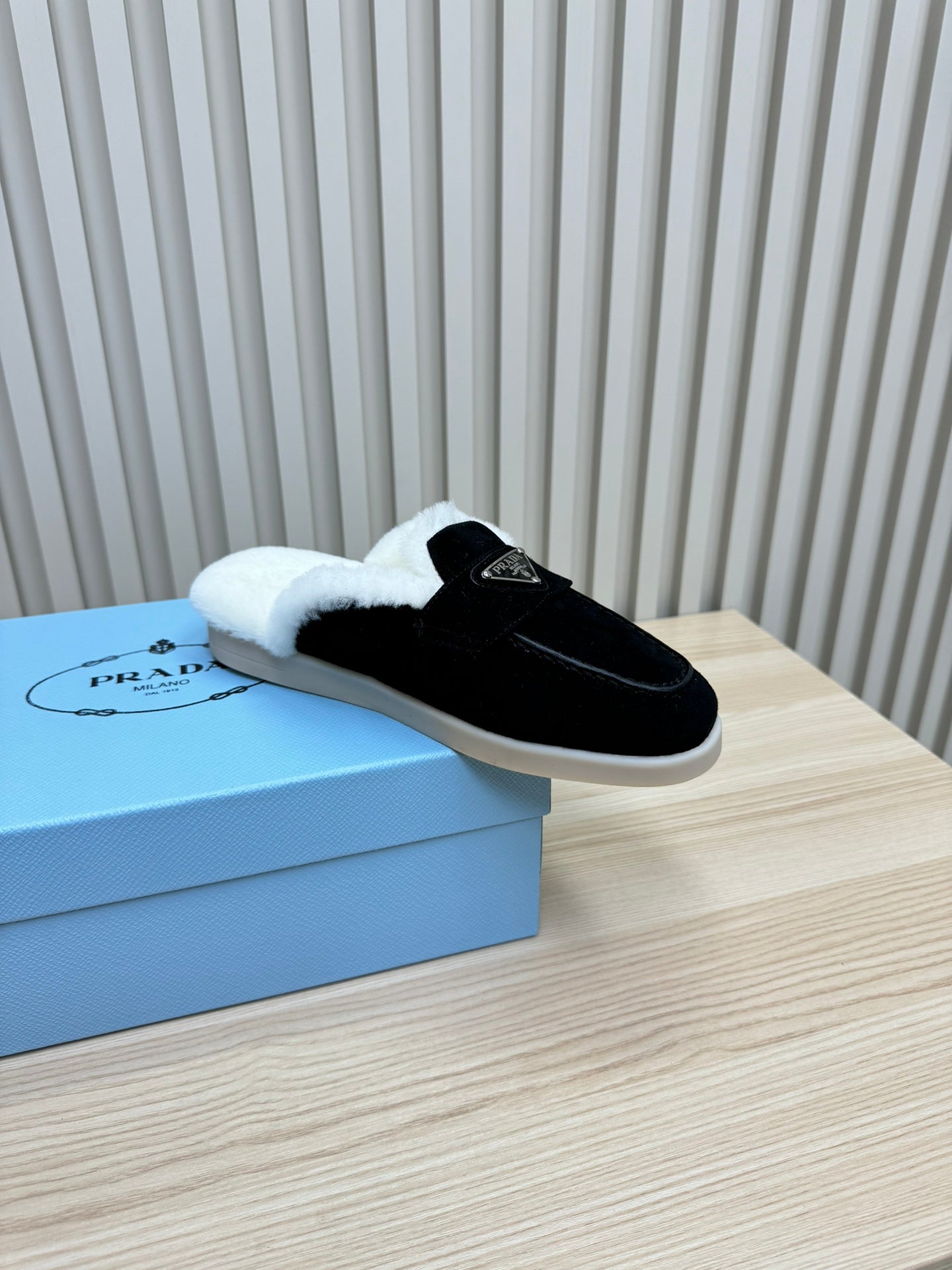 PRADA TRIANGLE LOGO FLATS IN BLACK SUEDE AND FUR LINING
