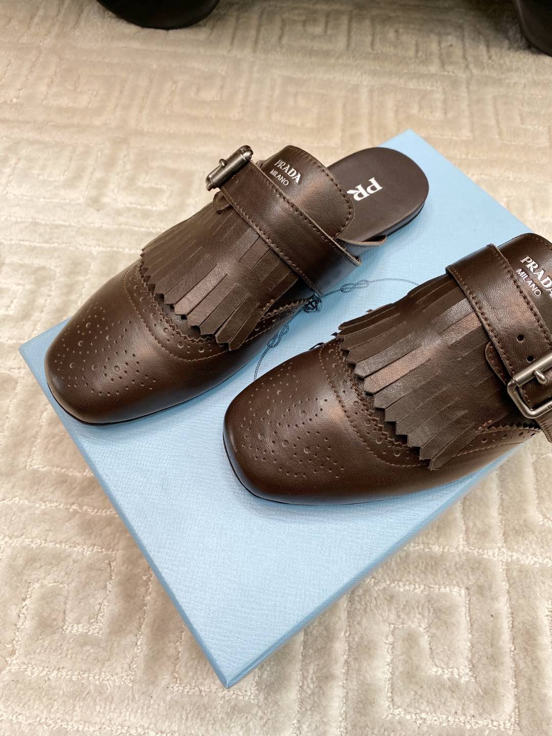 PRADA TASSEL MULES IN WALNUT BROWN LAMBSKIN