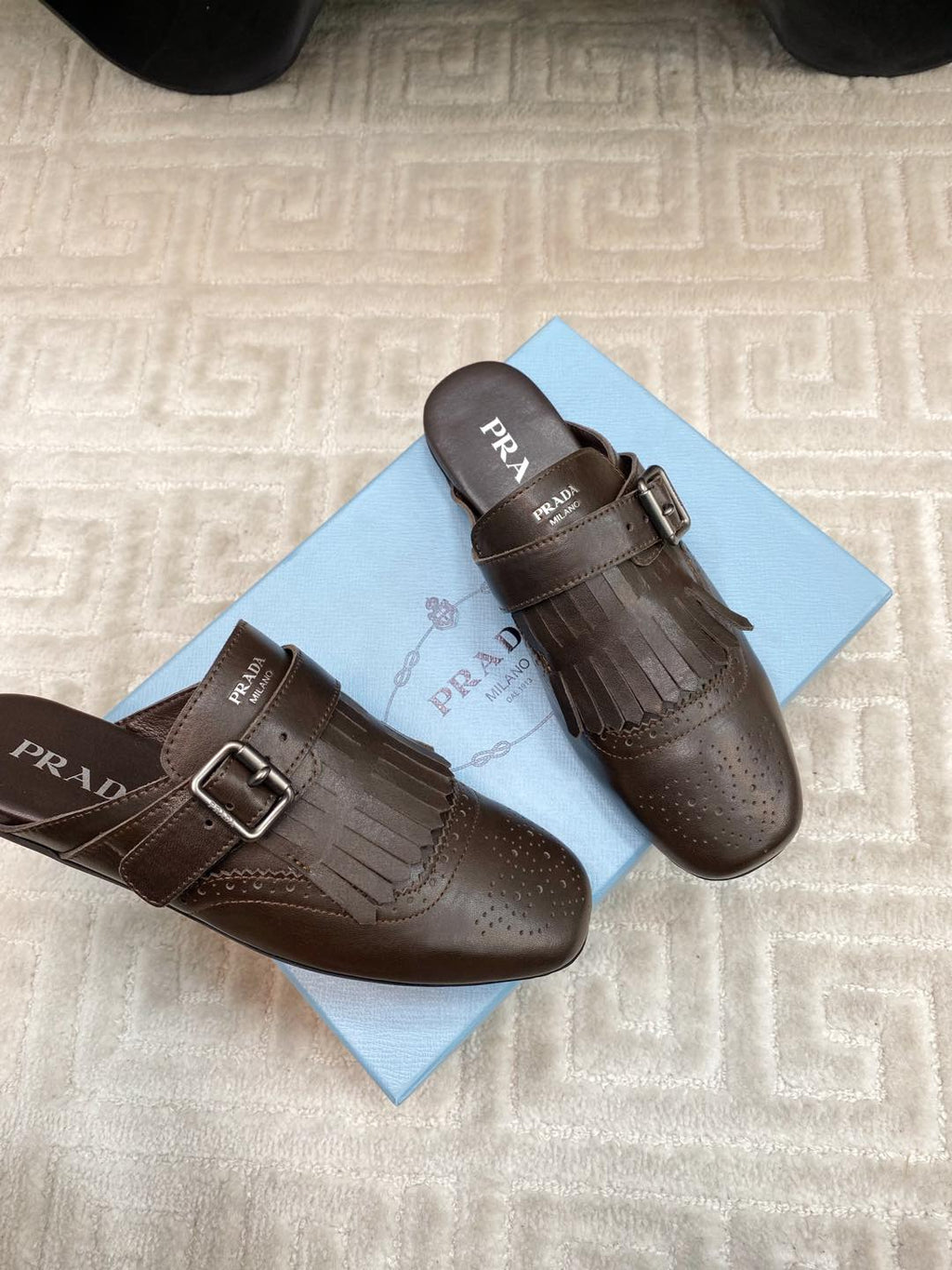 PRADA TASSEL MULES IN WALNUT BROWN LAMBSKIN