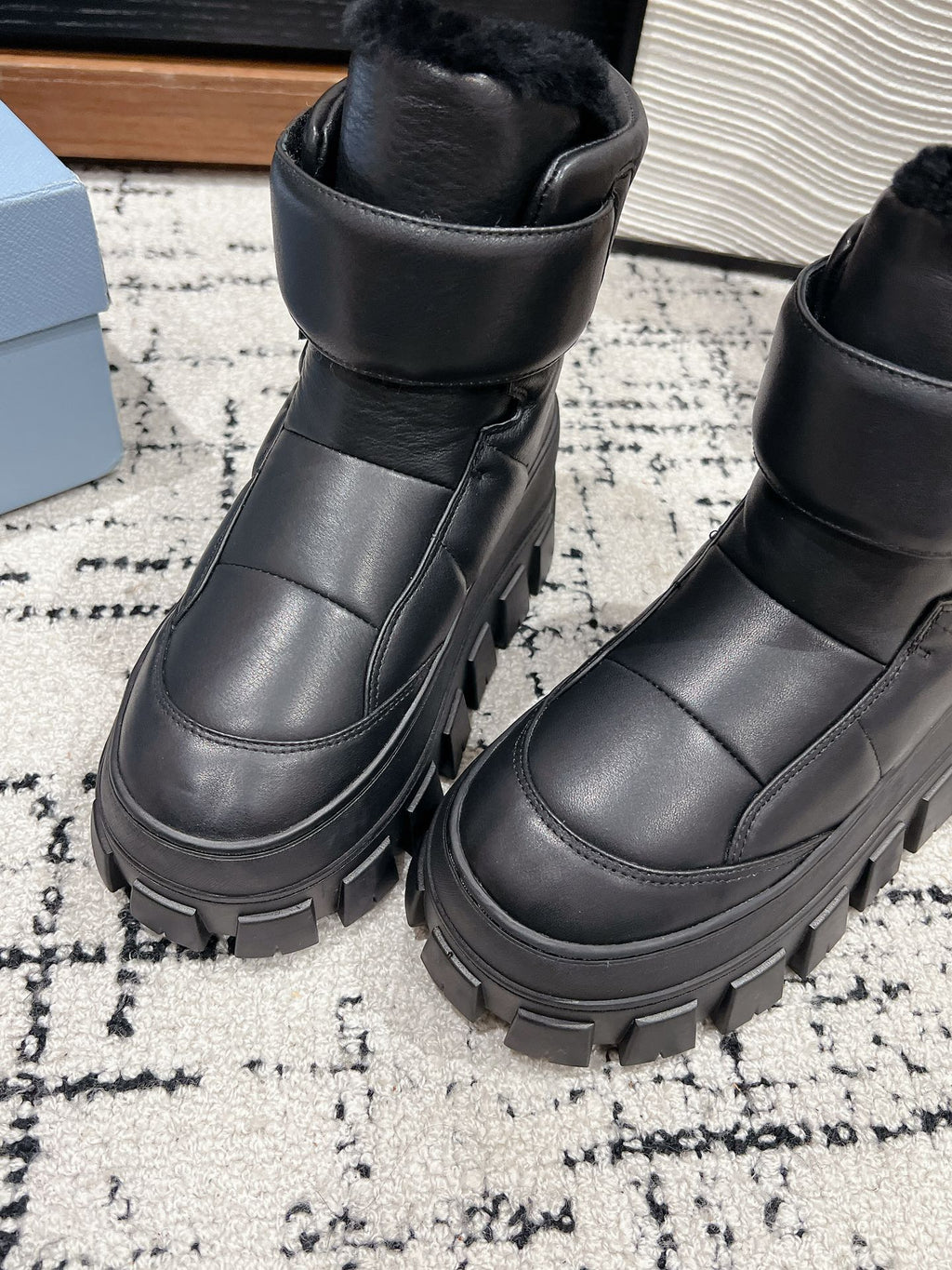 PRADA MONOLITH ANKLE BOOTS WITH STRAP IN BLACK CALFSKIN AND FLEECE LINING