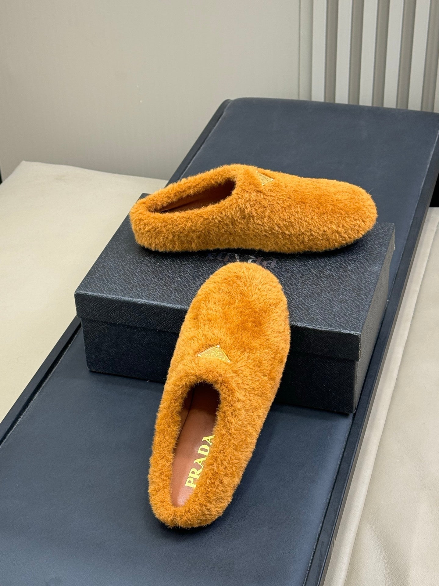 PRADA 25S CLOGS IN RK ORANGE SHEARLING