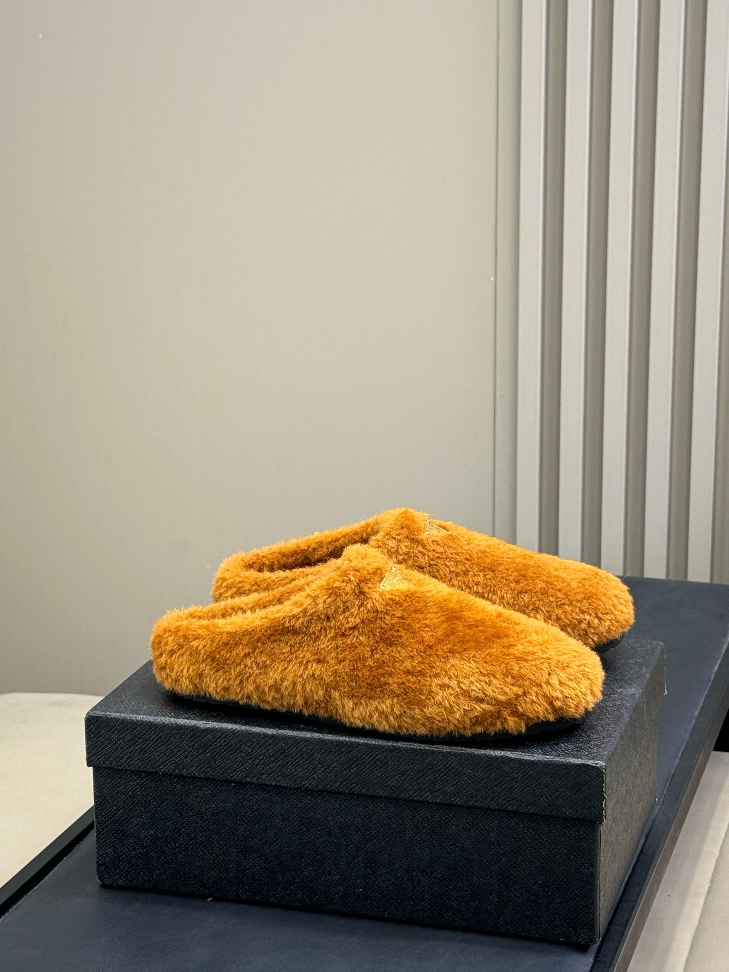 PRADA 25S CLOGS IN RK ORANGE SHEARLING